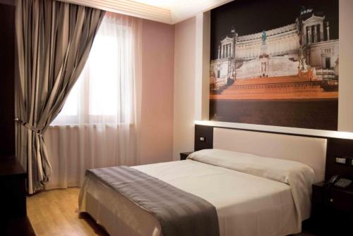 a bedroom with a bed with a picture on the wall at Hotel Star in Monterotondo