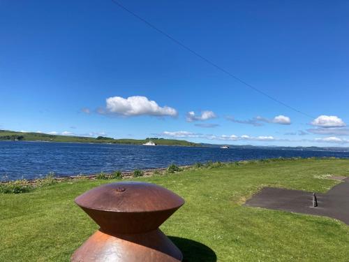 a statue of a hat next to a body of water at The Waterside Apartment 6 in Largs