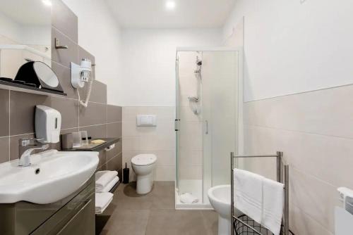 a bathroom with a sink and a toilet and a shower at Locazione Turistica Dal Degan in San Bonifacio