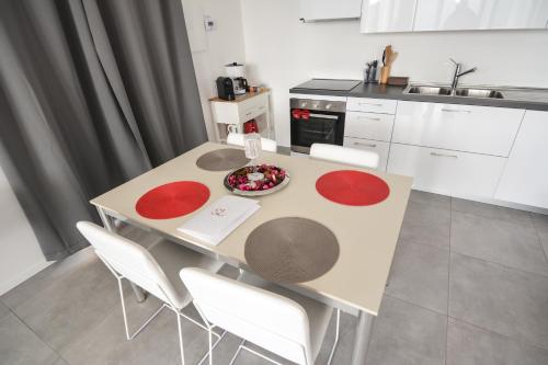 a kitchen with a table with red circles on it at Sunset Lodge - ENJOY HOLIDAY in Garda
