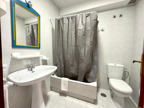 a bathroom with a sink and a toilet and a shower at Park Raxo in Raxó