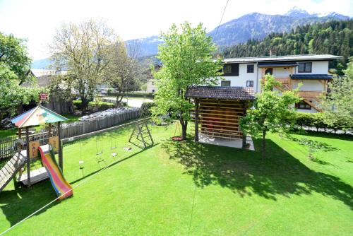 a large yard with a playground with a slide at Landhaus Zoppoth in Kötschach