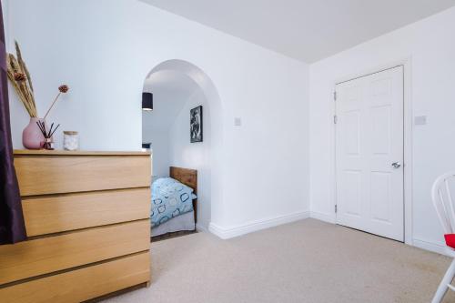 a bedroom with a dresser and a bed at Talbot House in Chester