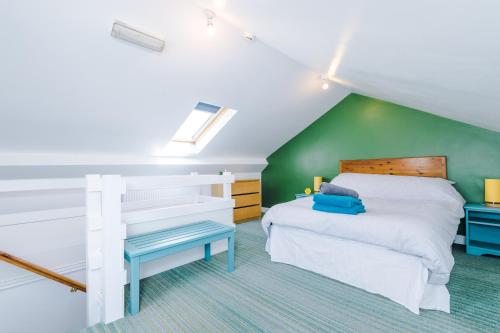 a bedroom with a white bed and a green wall at Talbot House in Chester