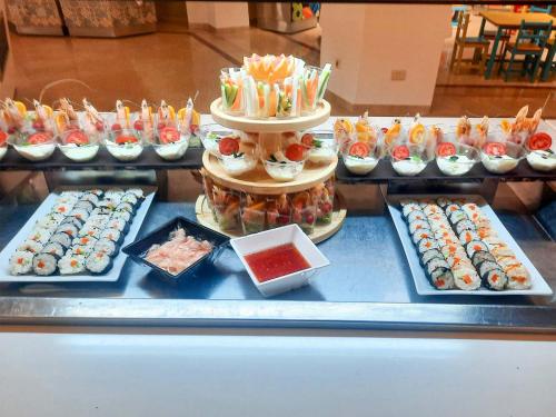a buffet with different types of sushi on a table at Monarque Club Rivage - VV in Monastir