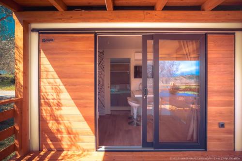 a glass door on the side of a house at Mobilheim Mate2 in Nin