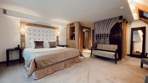 a large bedroom with a large bed and a bench at Dome Hotel in Rīga