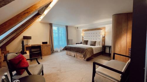 a bedroom with a bed and a desk and a chair at Dome Hotel in Rīga