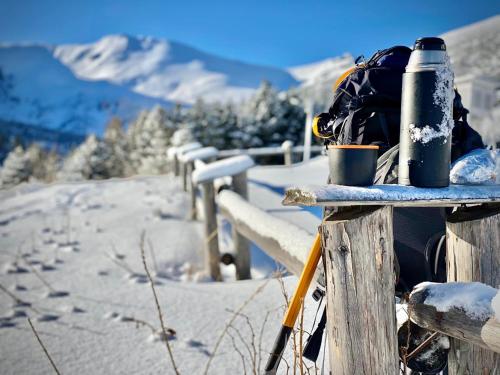 a backpack and a back pack on a fence in the snow at Malinovy Sen II in Habovka