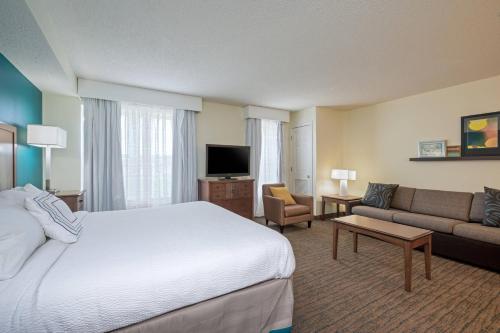 a hotel room with a bed and a couch at Residence Inn by Marriott Salisbury in Salisbury