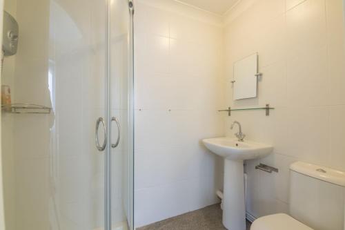 a bathroom with a shower and a sink and a toilet at Bosky House in South Creake