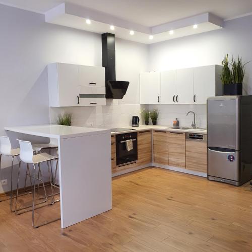 a kitchen with white cabinets and a white counter top at Good Time Apartments Garbary 71, Stare Miasto, ładny widok in Poznań