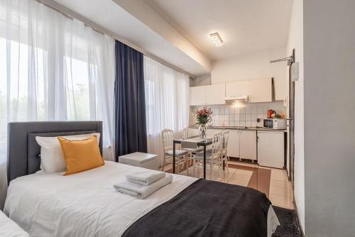 a bedroom with a large bed and a kitchen at Albert gare du Midi , 29 in Brussels