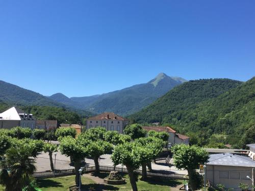 a view of a town with mountains in the background at Le Château Aspet B&B in Aspet