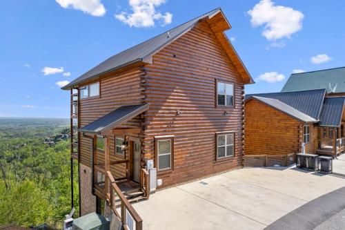 a log cabin with a large driveway in front of it at Dolly Valley View in Sevierville