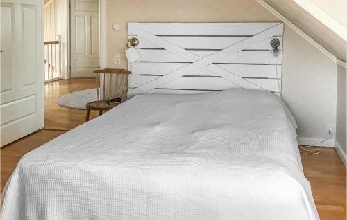 a bedroom with a white bed with a white headboard at Beautiful Home In Gvle With Sauna in Gävle