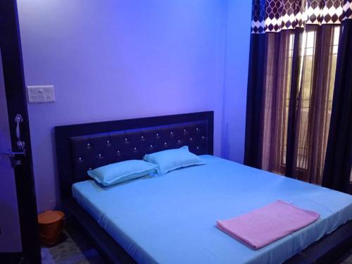a bedroom with a bed with two towels on it at SPOT ON Black Bird in Meerut
