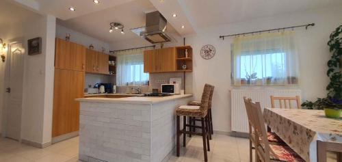 a kitchen with a counter and a table with chairs at Holiday home in Keszthely/Balaton 39648 in Keszthely