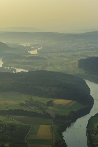 an aerial view of a river with fields and trees at Hotel Rheingold in Gailingen