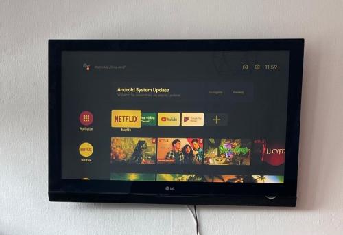 a television screen with a website on it at City Center Apartment in Katowice