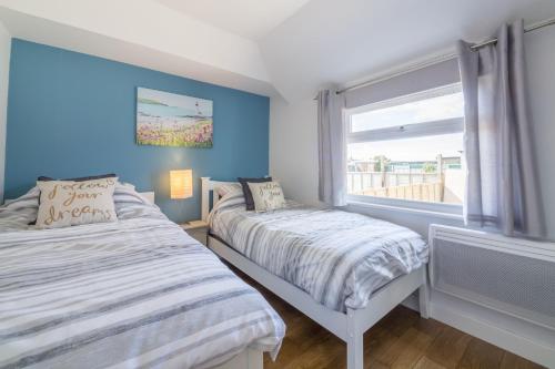 a bedroom with two beds and a window at Wyndham Beach House in Walcott