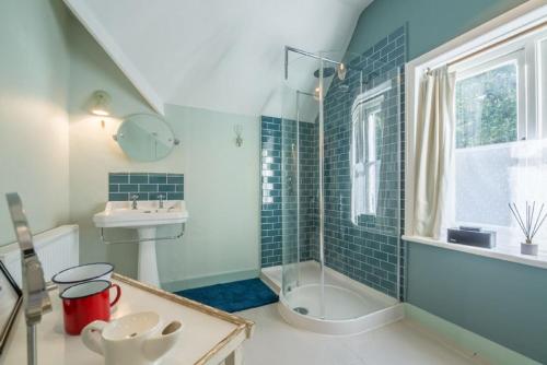 a bathroom with a sink and a bath tub at Station House in Helhoughton