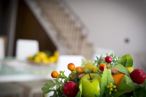 a arrangement of fruits and vegetables on a table at B&B Piano di Sopra in San Vito lo Capo