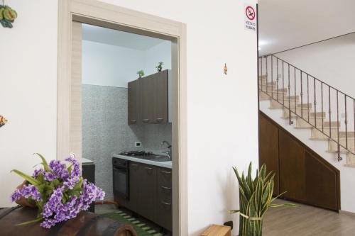 a kitchen with a sink and a stove at B&B Piano di Sopra in San Vito lo Capo