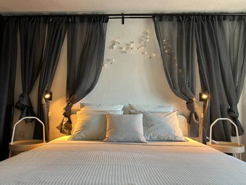 a bedroom with a large bed with drapes at Centrum Bol Apartment - One Minute from the Sea in Bol