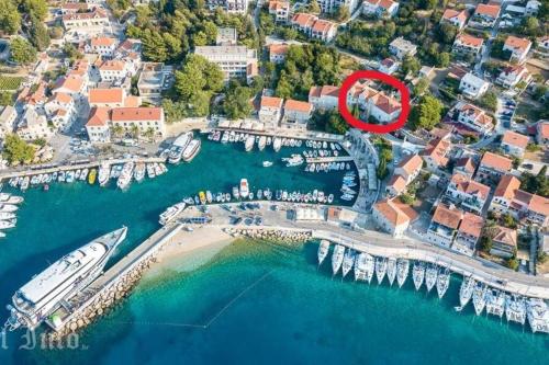an aerial view of a marina with a boat in the water at Centrum Bol Apartment - One Minute from the Sea in Bol