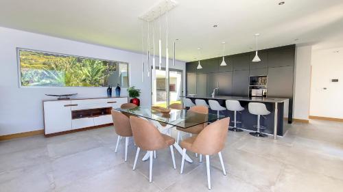 a kitchen with a glass table and chairs at Villa Blue Horizon by LovelyStay in Tábua