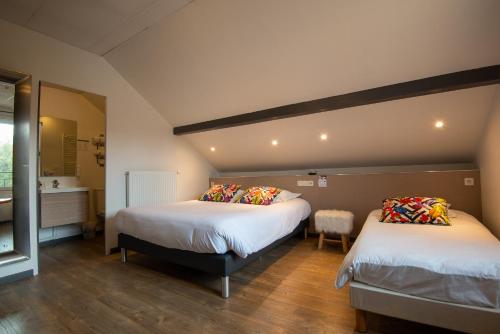 a room with two beds and a sink in it at Contact hôtel Les Ailes in Challes-les-Eaux