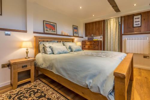 a bedroom with a large bed in a room at The Signal Box in Melton Constable