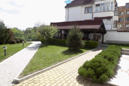 a house with a walkway in front of a yard at Spa Villa Crystal in Hisarya