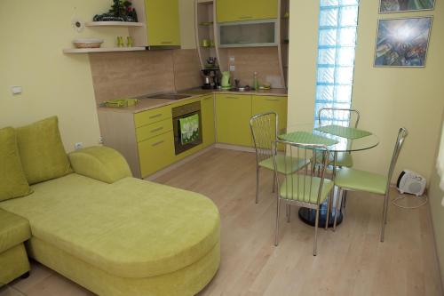 a living room with a couch and a table and a kitchen at Spa Villa Crystal in Hisarya