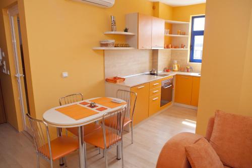 a small kitchen with a table and chairs in it at Spa Villa Crystal in Hisarya