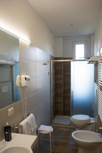 a bathroom with a shower and a toilet and a sink at eco Hotel Milano & BioRiso Restaurant in Milan