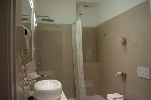 a bathroom with a shower and a toilet and a sink at eco Hotel Milano & BioRiso Restaurant in Milan