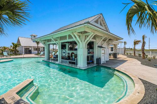 a pool with a gazebo next to a house at Fairway to Heaven in Port Aransas