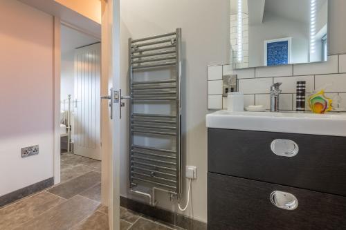 La salle de bains est pourvue d'un lavabo et d'un miroir. dans l'établissement Peterstone Lodge, à Holkham