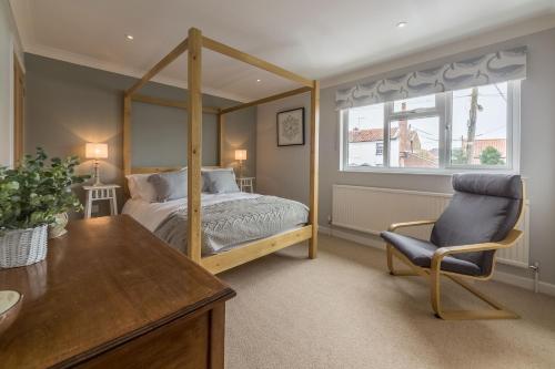 a bedroom with a bed and a chair and a desk at Kipling House 8 in Wells next the Sea