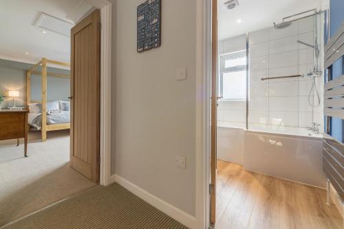 a hallway with a glass door leading to a bedroom at Kipling House 8 in Wells next the Sea