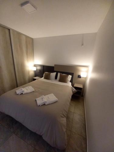 - une chambre avec un grand lit et des serviettes dans l'établissement Orfila Apart 4, à Mendoza