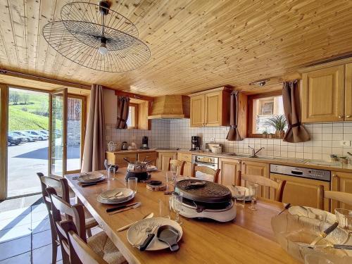 une cuisine avec une grande table en bois et des chaises dans l'établissement Chalet spacieux avec sauna, proche des Menuires et St Martin de Belleville - FR-1-344-738, à Saint-Marcel