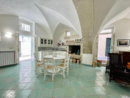 a kitchen with a table and chairs in a room at Casa Maricla - Marea Collection in Otranto