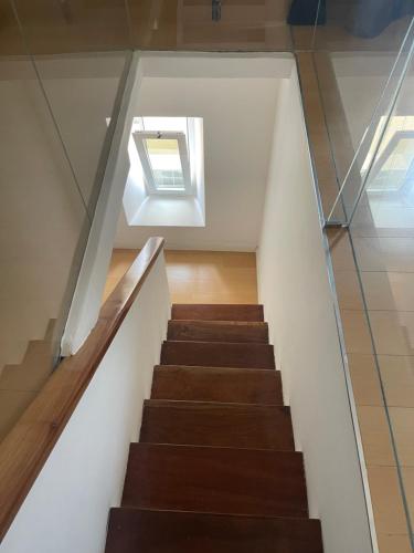a staircase in a house with a skylight at KAZARÃO DI MAVETE- Guesthouse in Praia