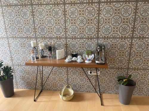 a table in front of a wall with a wallpaper at KAZARÃO DI MAVETE- Guesthouse in Praia