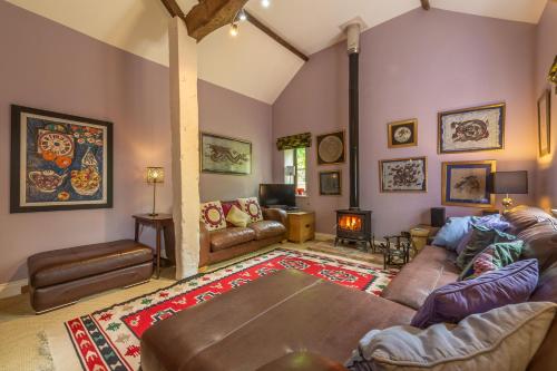 a living room with a couch and a table at Apple Tree Barn in Langham