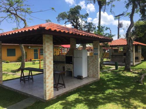 a gazebo with a kitchen in a park at Chalé 31 in Florianópolis