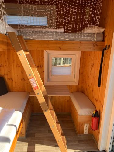 a tiny house with two bunk beds and a window at Tiny House Lodge Dresden in Dresden